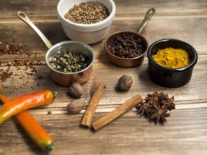 Aromatic chai masala spices including cardamom, cinnamon, star anise, and cloves