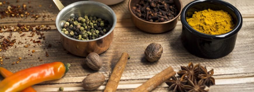 Aromatic chai masala spices including cardamom, cinnamon, star anise, and cloves