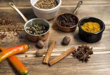Aromatic chai masala spices including cardamom, cinnamon, star anise, and cloves