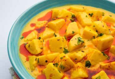 Dahi wale Aloo or Aaloo or yogurt or curd potato curry, an Indian Classical dish, served in bowl with naan. selective focus